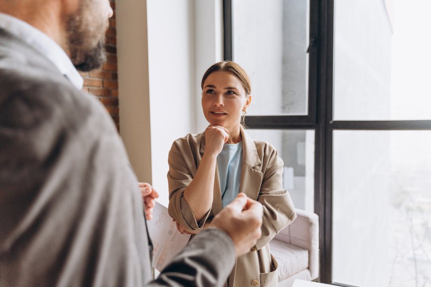 Young Business Women Looking at Her Colleague