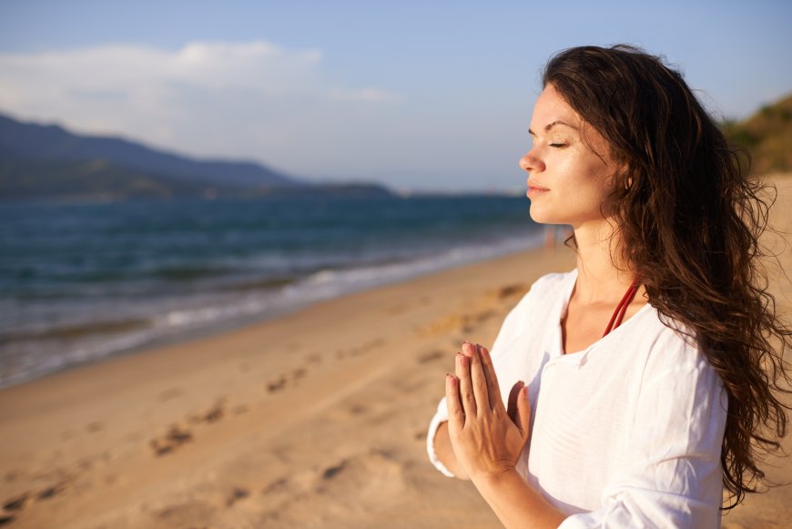 Women Meditating on Beach