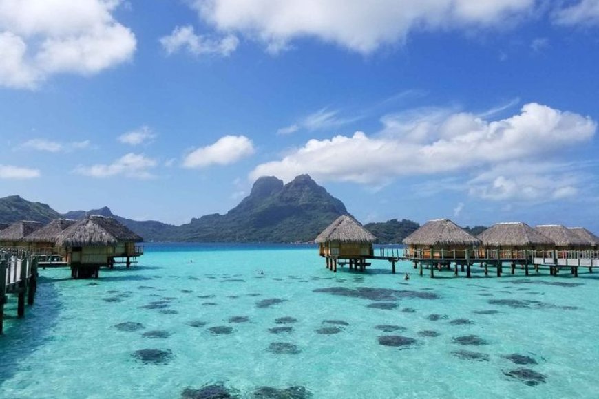 Which beach destination is famous for its overwater bungalows and crystal-clear lagoons?